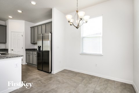 a kitchen with a refrigerator and a window
