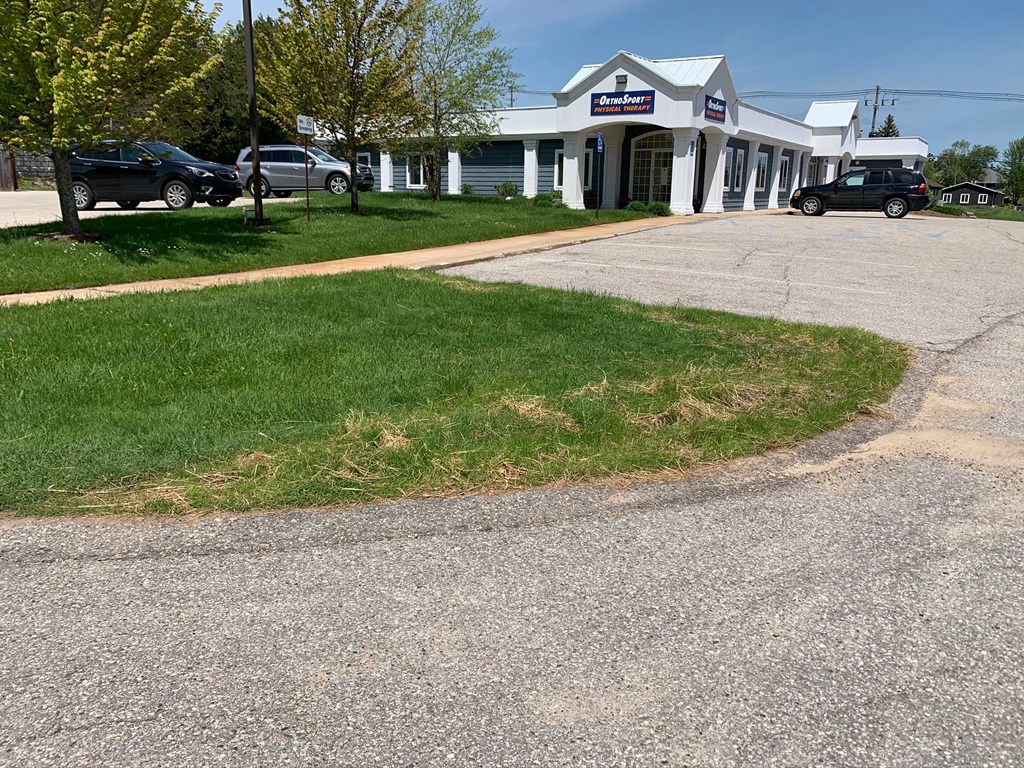 a white building with cars parked in front of it