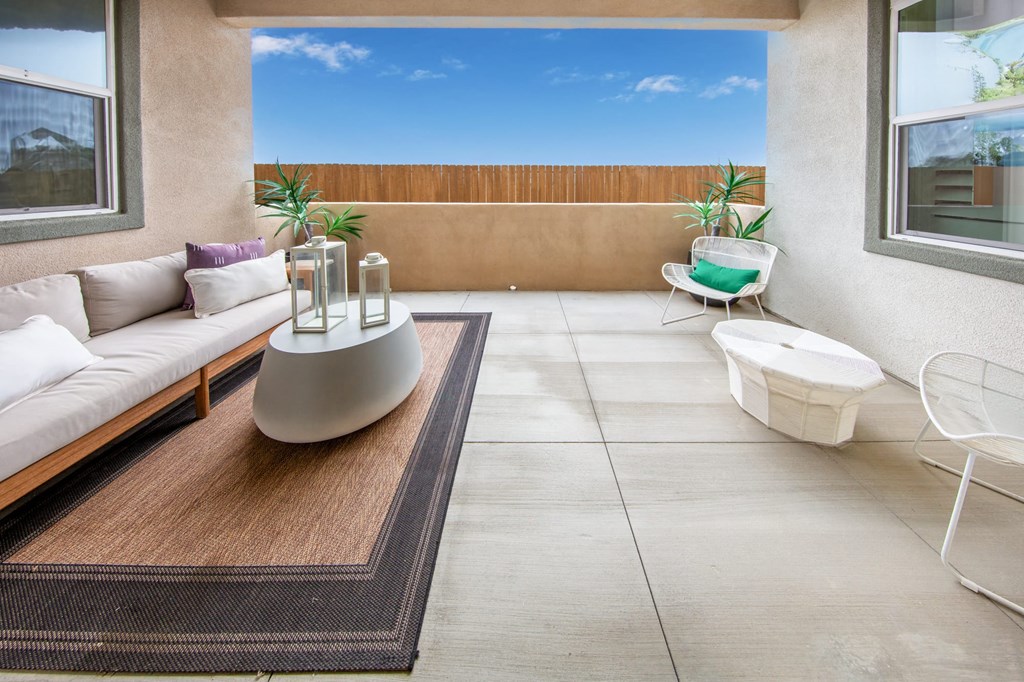 a patio with a couch and a coffee table