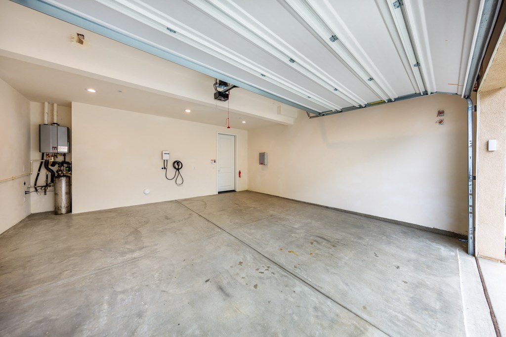 the interior of a garage with a concrete floor and white walls