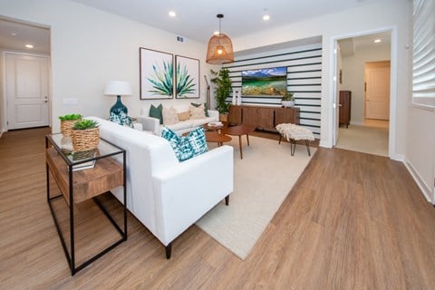 a living room with a white couch and a table