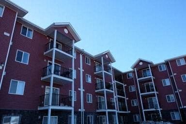 an apartment building with balconies and a blue sky