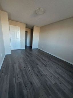 a empty room with wooden floors and a door
