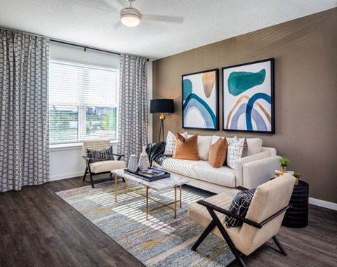 our apartments offer a spacious living room with a couch and chairs