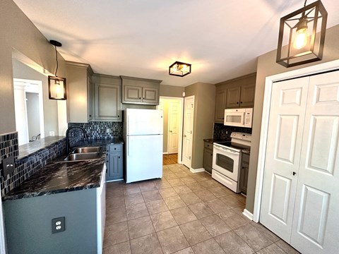 a kitchen with a sink and a refrigerator