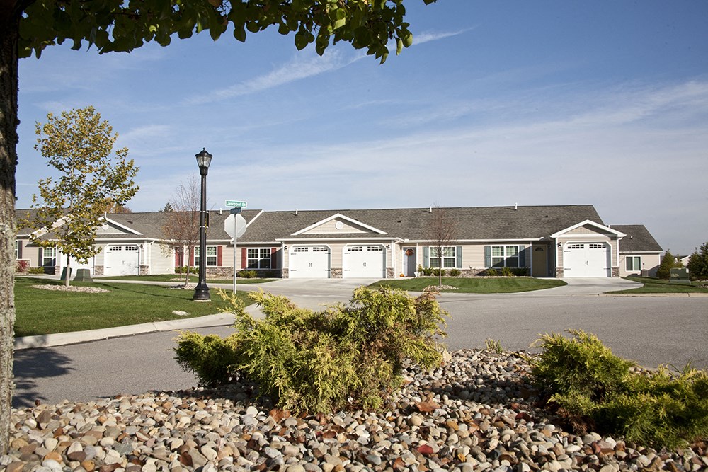 a group of houses in front of a parking lot