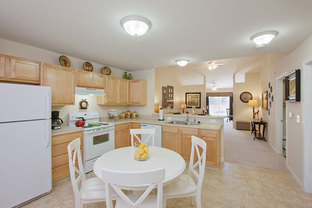 a kitchen and dining room with a white table and chairs