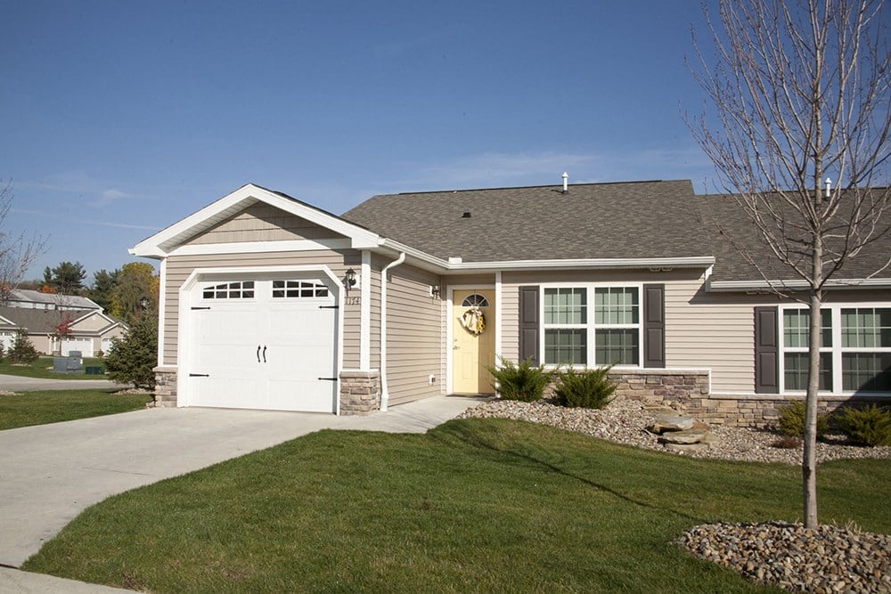 a house with a driveway and a white garage door
