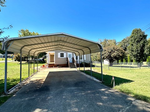 A covered walkway leads to a house.