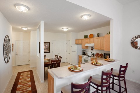 an open kitchen and dining area with a dining table and chairs