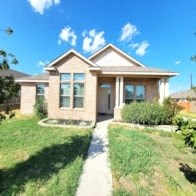 a house with a sidewalk and grass in front of it
