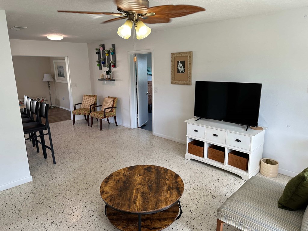 a living room with a tv and a table