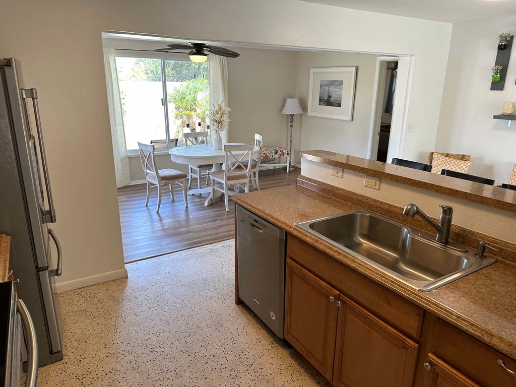a kitchen with a stainless steel sink and a counter top