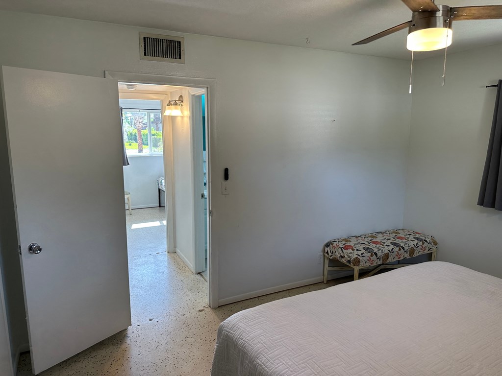 a bedroom with a bed and a door to a bathroom