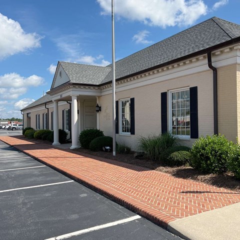 the front of a building with a porch and columns