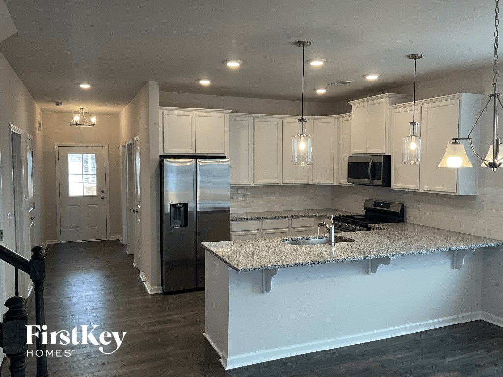 a kitchen with white cabinets and a counter top