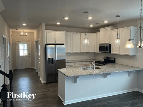 a kitchen with white cabinets and a counter top