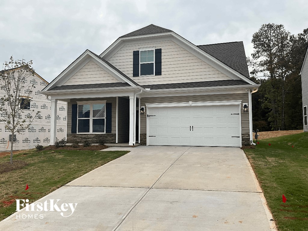 a house with a white garage door and a driveway