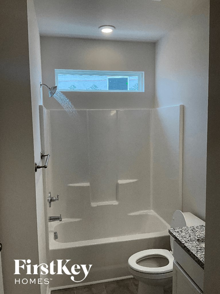 a small bathroom with a shower and a toilet