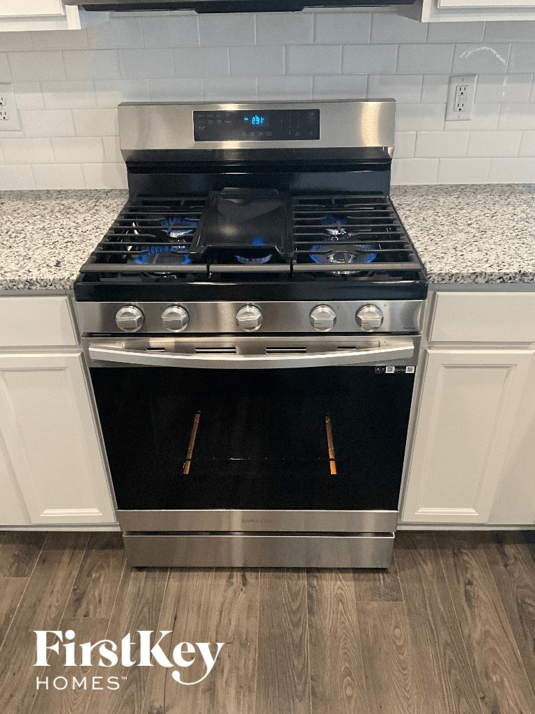 an oven in a kitchen with white cabinets