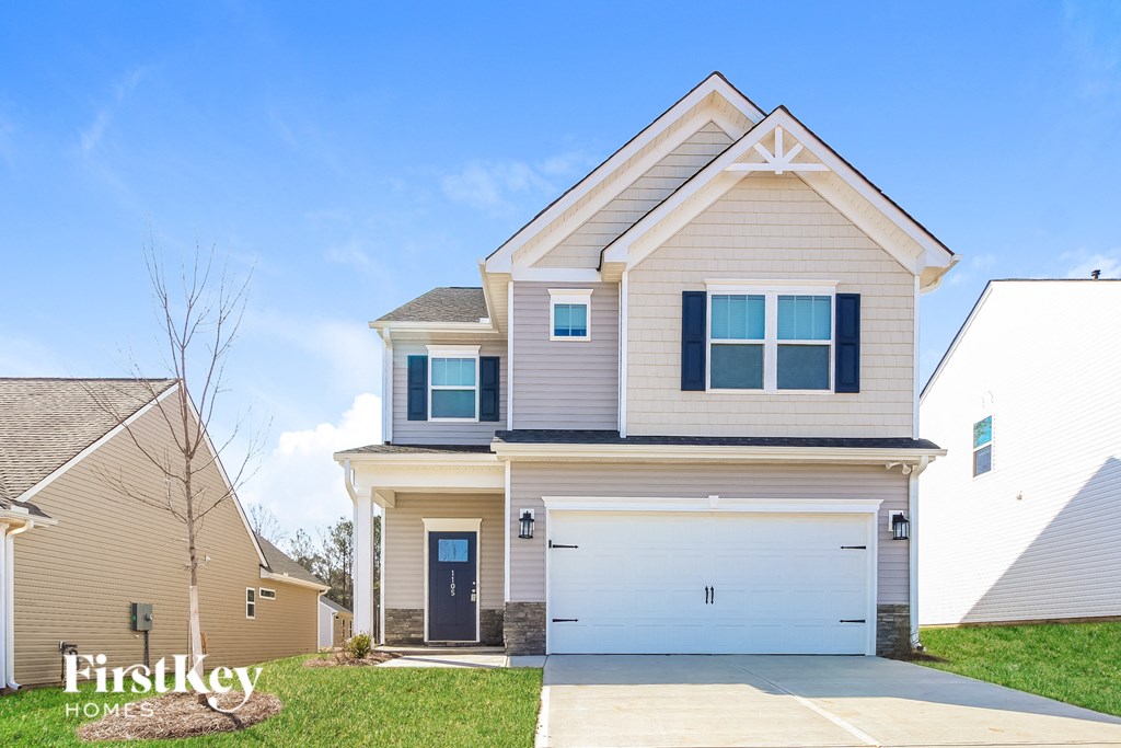 a beige and white house with a white garage door