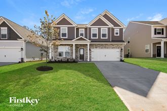 a large house with a driveway and a lawn