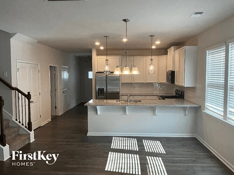 a kitchen with white cabinets and a counter top