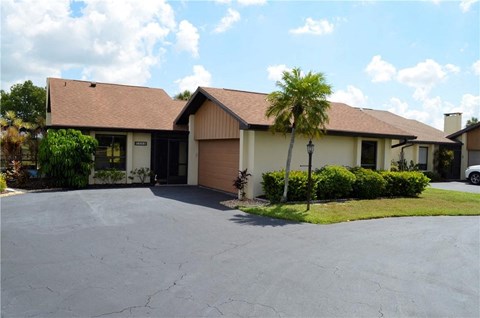 a house with a palm tree in front of it