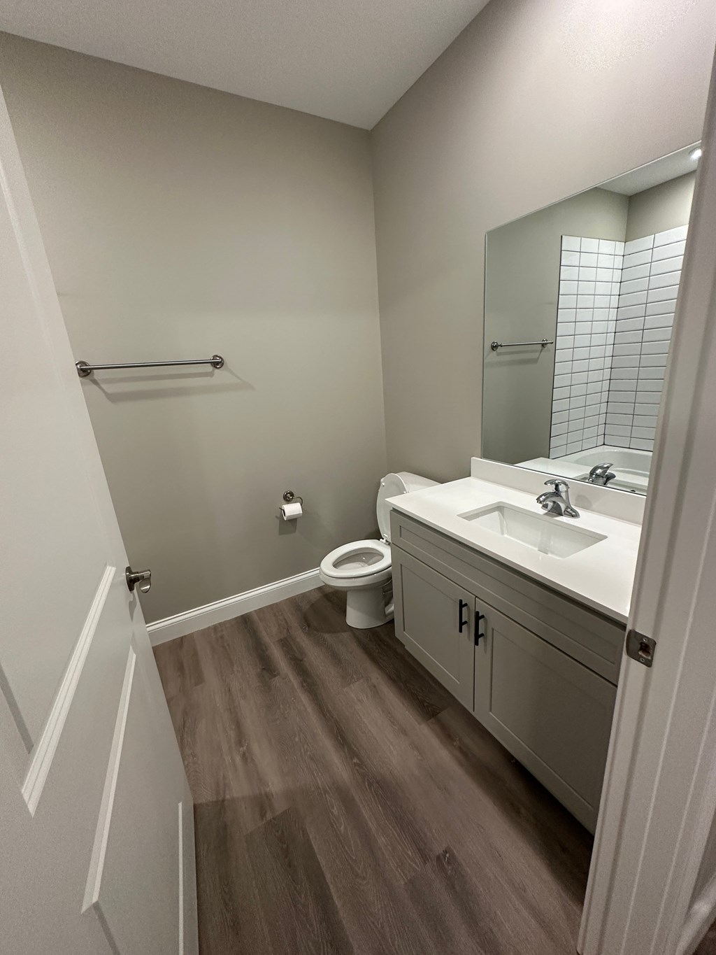 a bathroom with a sink and a toilet and a mirror