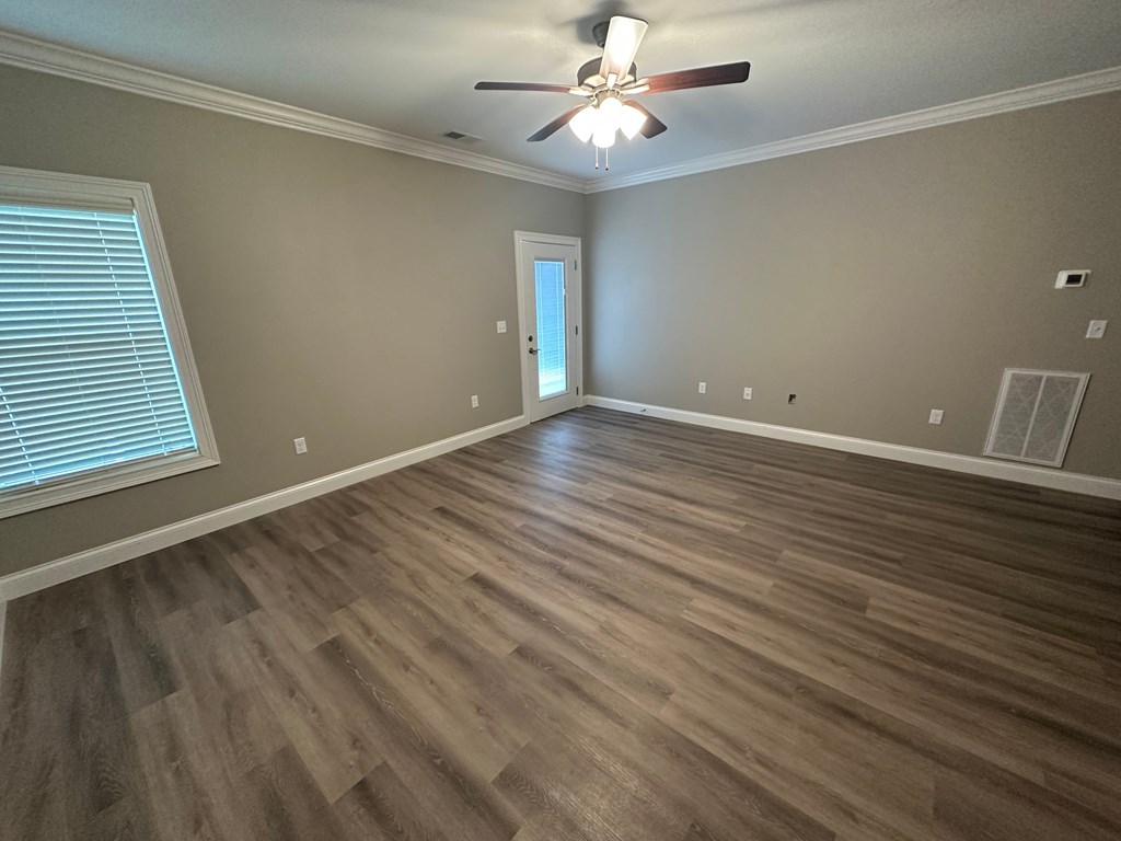 a living room with hardwood floors and a ceiling fan