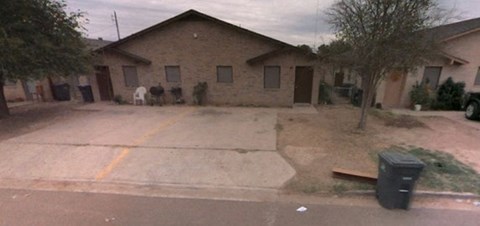 a house with an empty driveway in front of it
