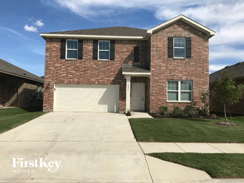 a large brick house with a white garage door