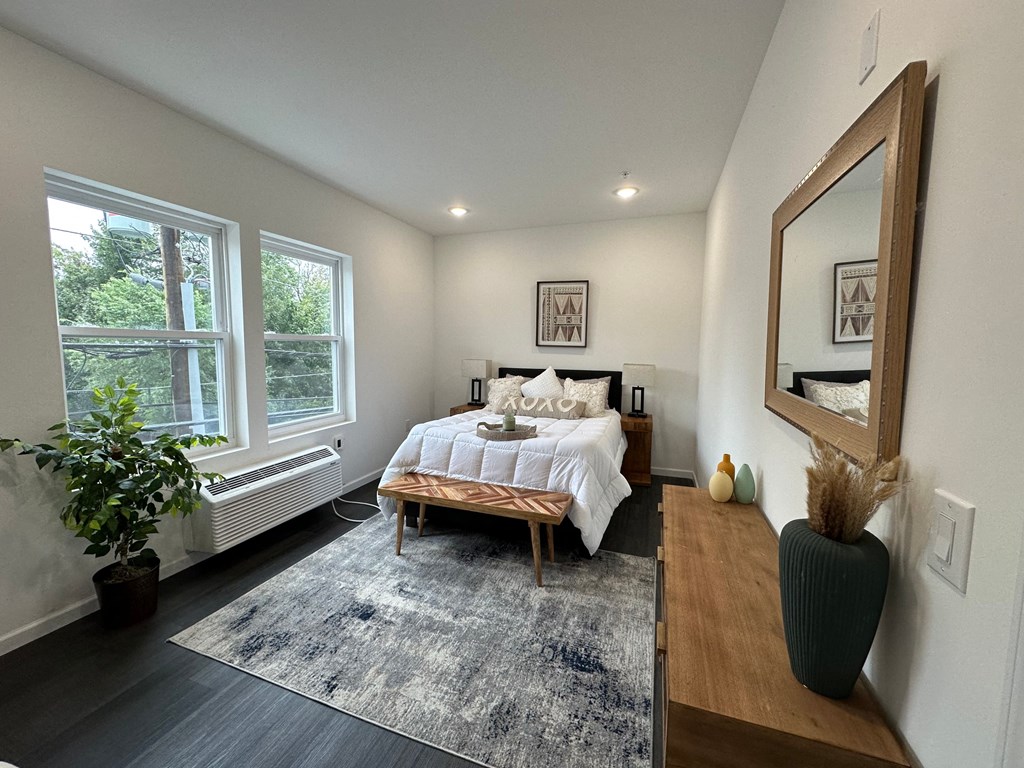 a bedroom with a bed and a large window