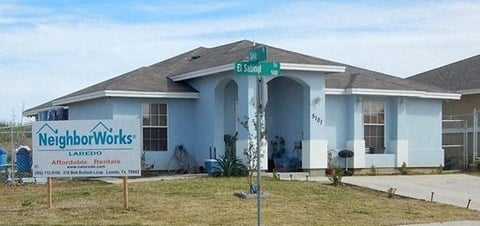 a blue house with a street sign in front of it