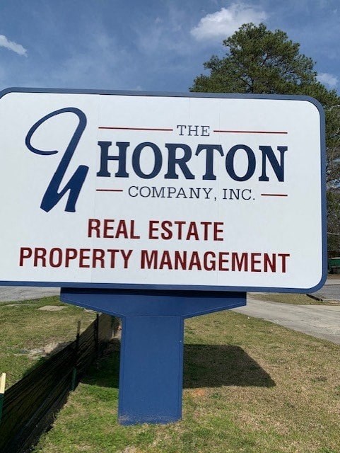 a sign for the horton company and real estate property management