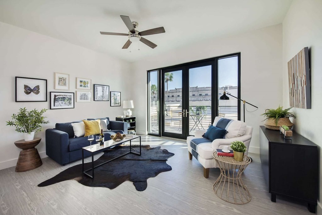 a living room with a couch and a ceiling fan