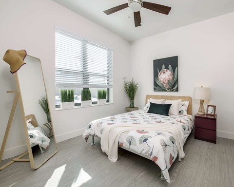 a bedroom with a bed and a ceiling fan