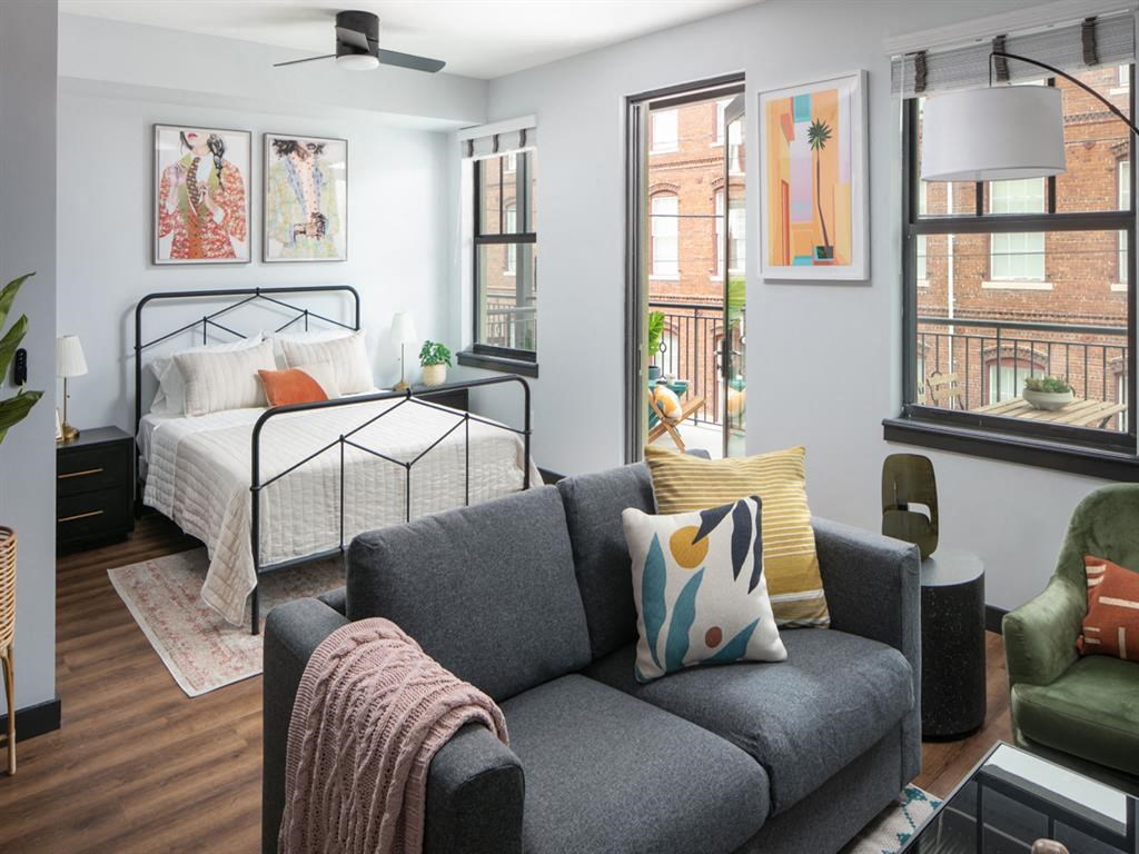 a bedroom with a bed and a couch in a living room