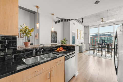 a kitchen with a sink and a window and a dining room