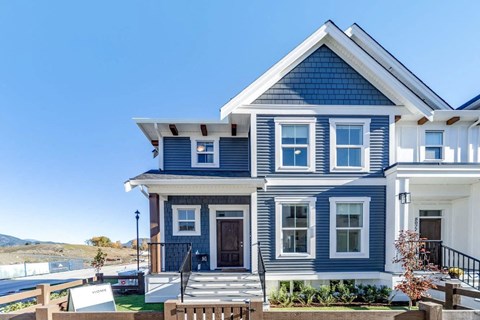 a blue house with a bench in front of it