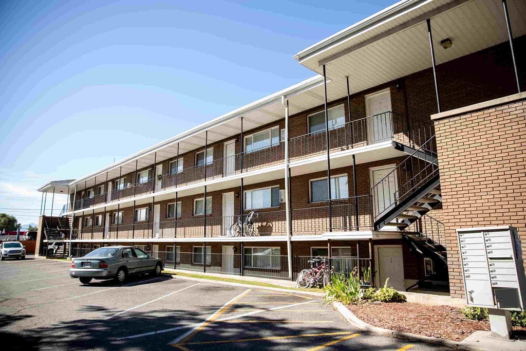 a car parked in a parking lot in front of a building