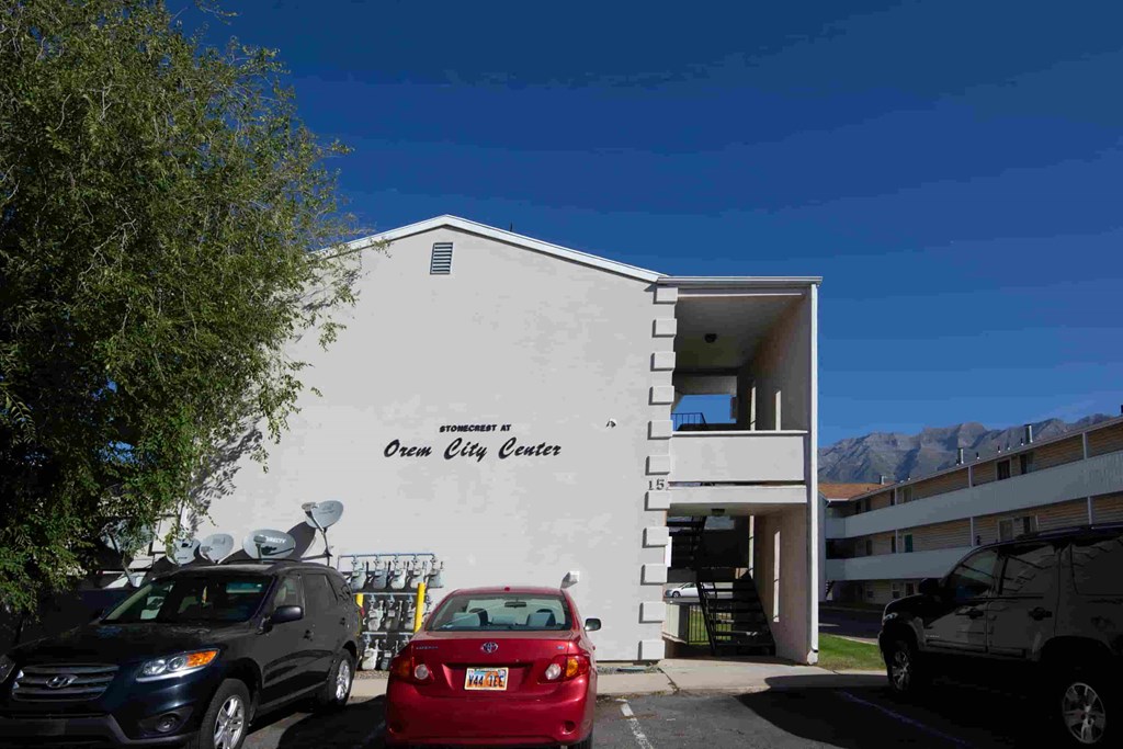a white building with cars parked in front of it