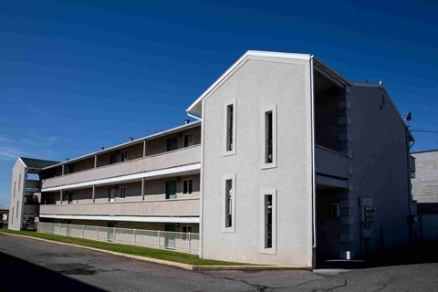 a large white building with a blue sky in the background