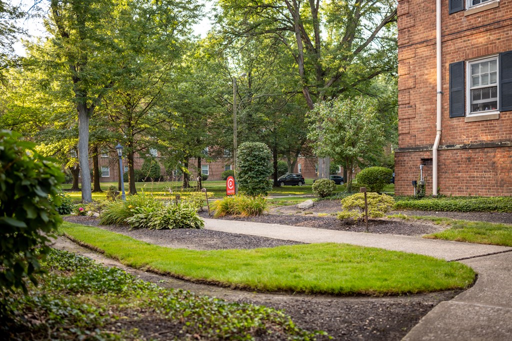 a sidewalk in front of a brick building