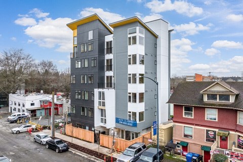 the apartment building is being constructed on the corner of a city street