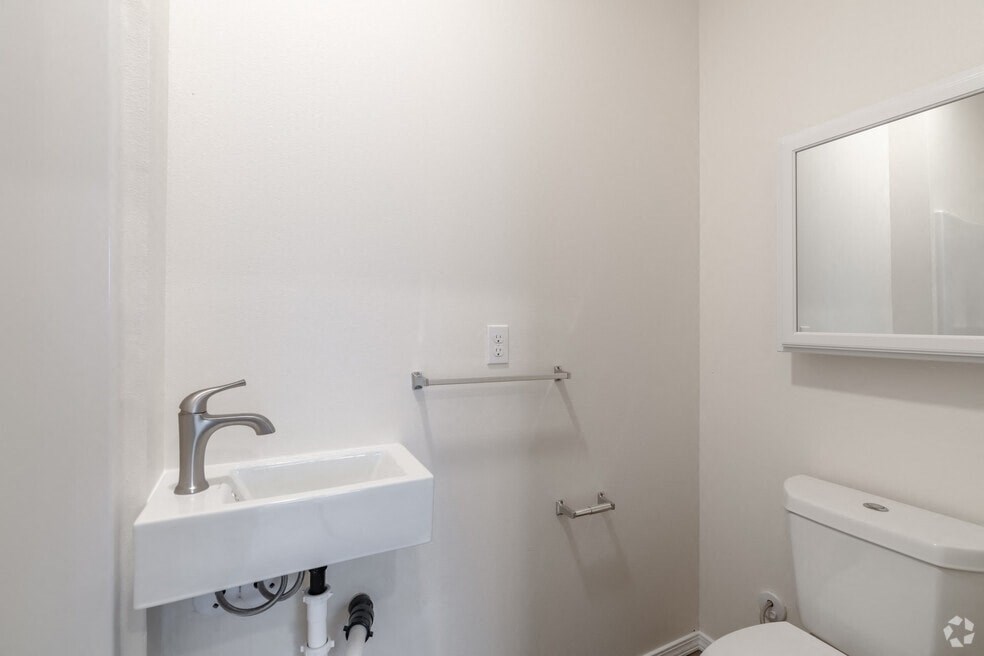 a white bathroom with a sink and a toilet