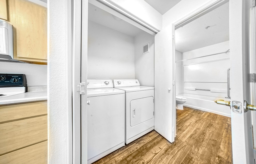 a small laundry room with a washer and dryer and a door to a