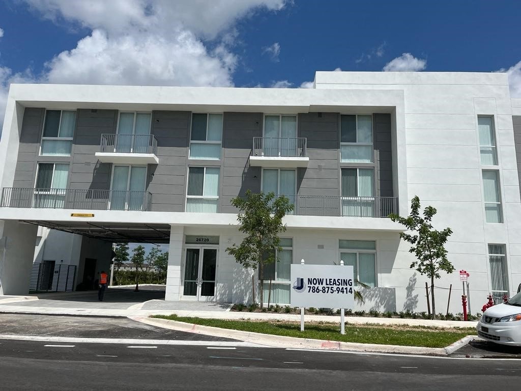 a white building with a sign in front of it