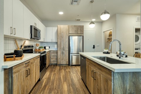 a kitchen with stainless steel appliances and wooden cabinets