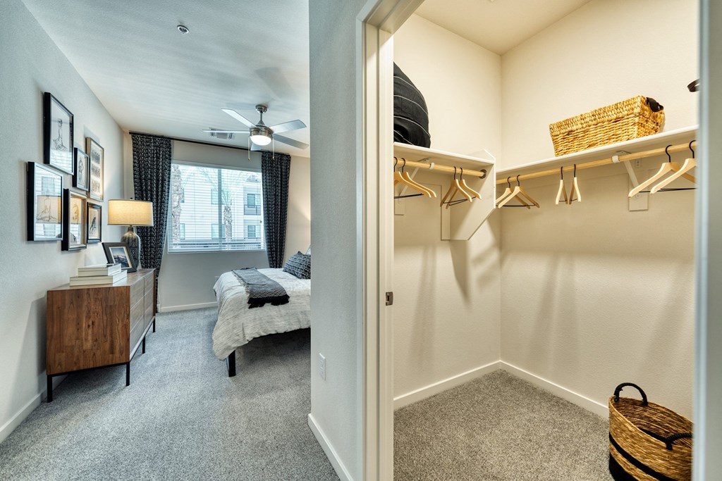 a bedroom with a closet and a bed and a ceiling fan